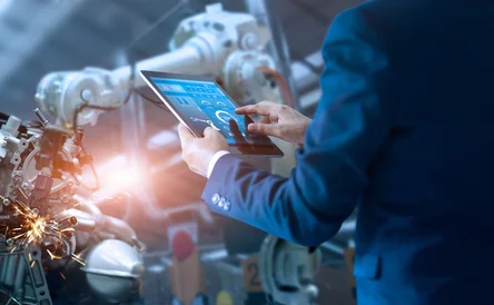 Manager engineer check and control automation robot arms machine in intelligent factory industrial on real time monitoring system software. Welding robotics and digital manufacturing operation.