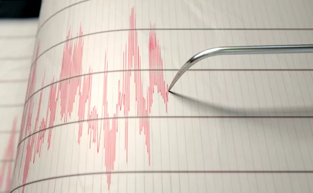 A closeup of a seismograph machine needle drawing a red line on graph paper depicting seismic and eartquake activity - 3D render