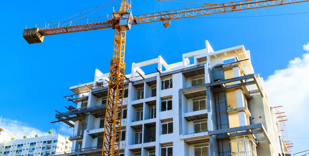Apartments construction site with yellow crane