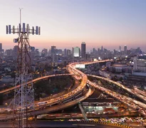 Telecommunication tower with 5G cellular network antenna on city background