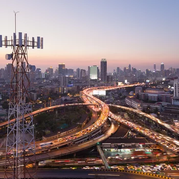 Telecommunication tower with 5G cellular network antenna on city background